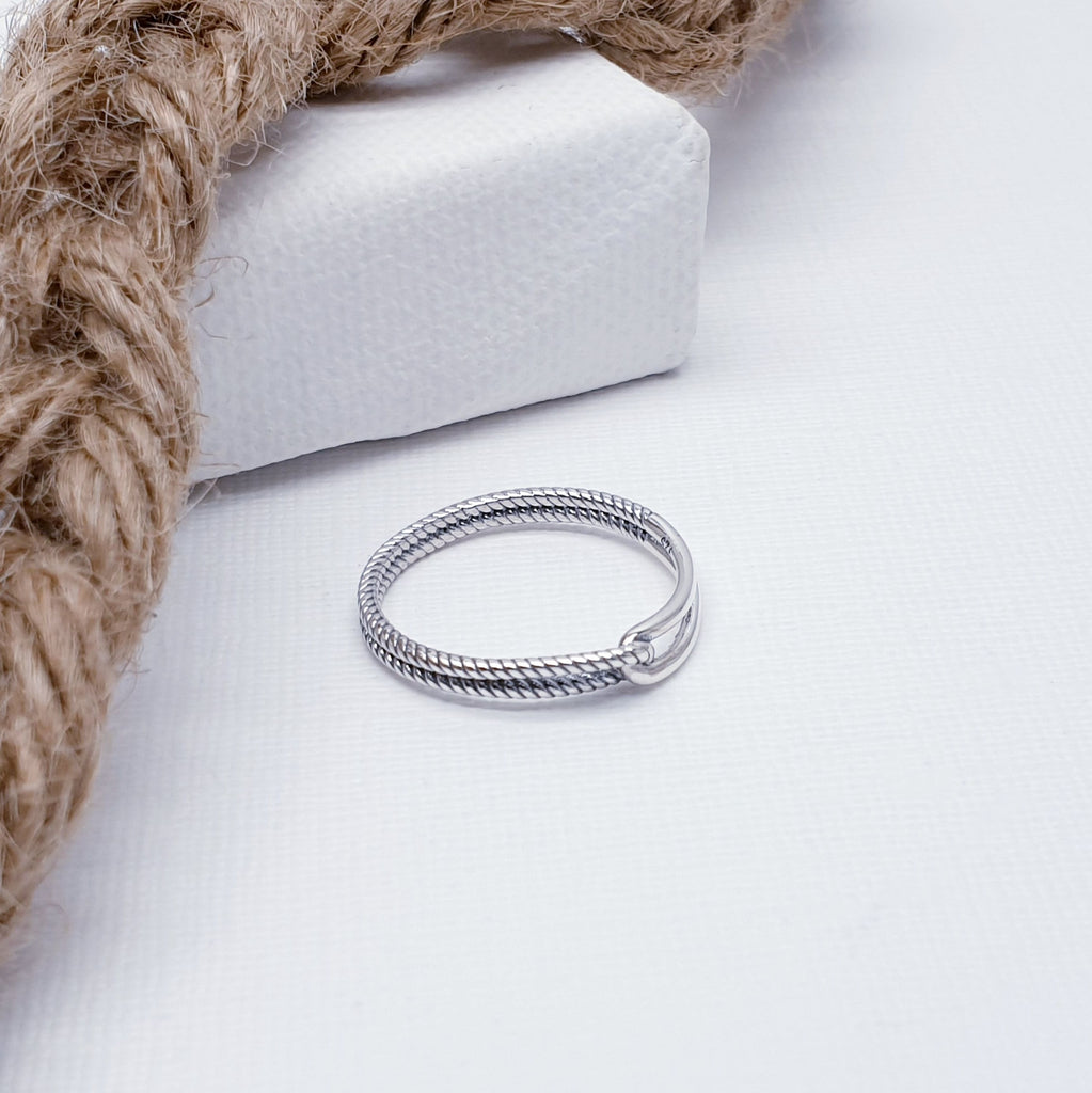 Our Sterling Silver Linked Rope Ring is perfect for everyday wear or special occasions.  A simple and dainty design, this ring features a rope style effect band linked with a polished loop at the front. The perfect accessory to any outfit, this ring will complement any style and is bound to be well received.