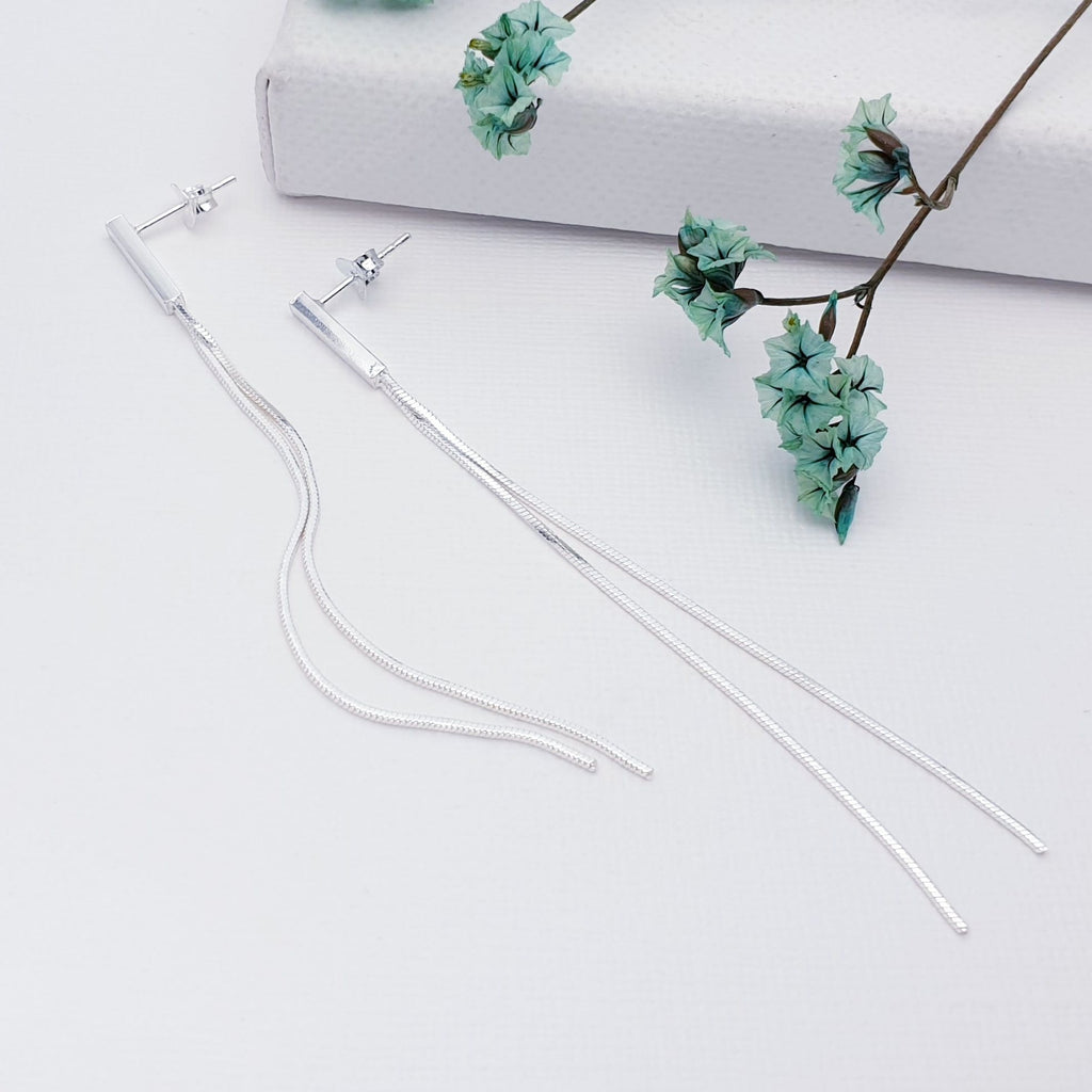 Stud drop earrings featuring a rectangle stud attachment with two long fine box chains.