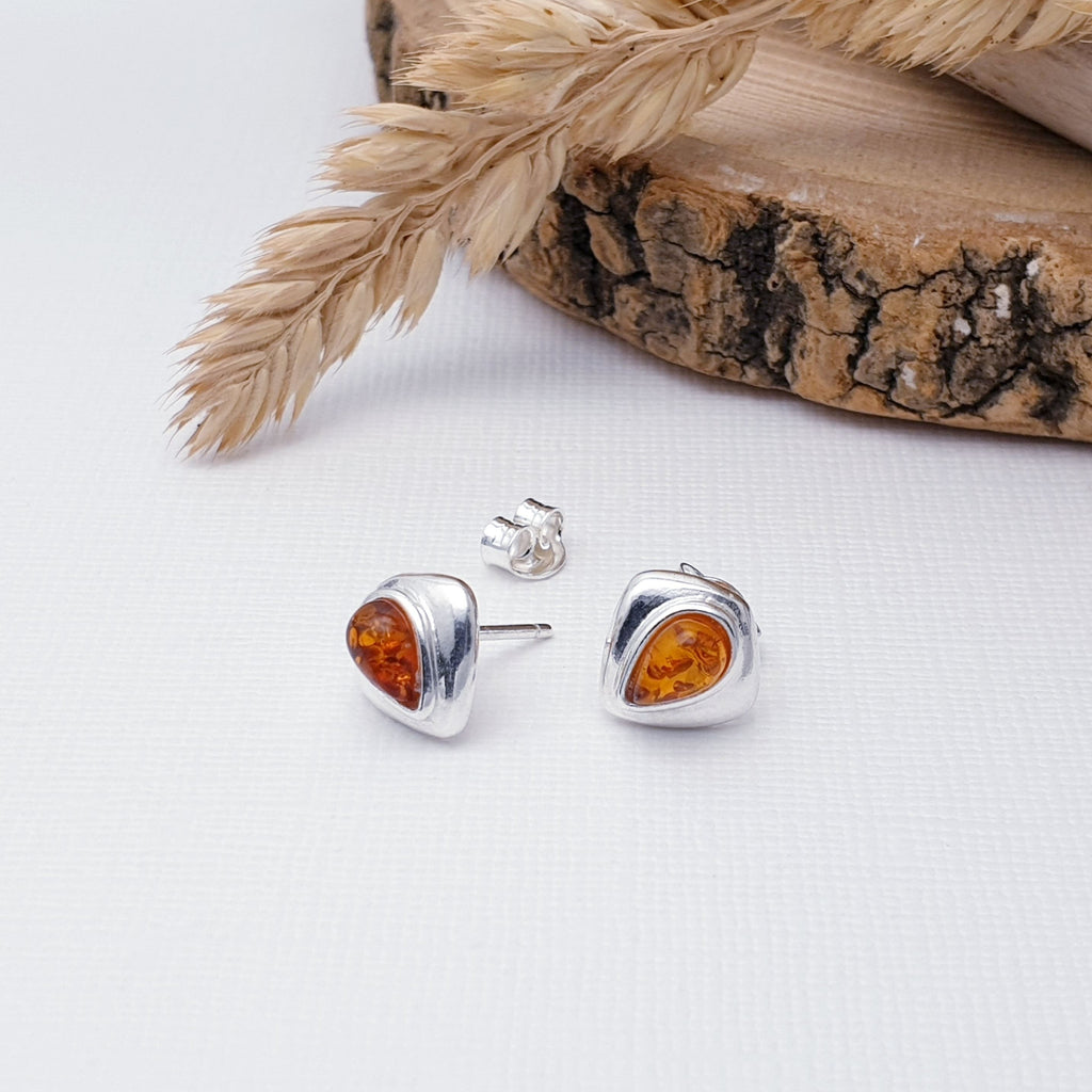 Our Toffee Amber Sterling Silver Curvilinear Studs are perfect for everyday wear.  Add rich colour and effortless style to your look with these beautiful amber sterling silver studs. Perfectly sized and set in a shield-like design, these studs are sure to make a subtle yet stunning statement.