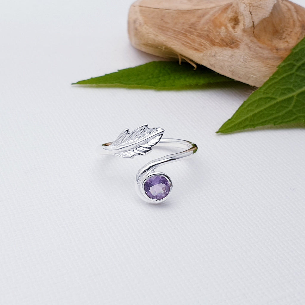 Our Amethyst Sterling Silver Leaf Ring is perfect for everyday wear or special occasions.  This elegant Amethyst Sterling Silver Leaf Ring is set with a beautiful round cabochon Amethyst stone and detailed with an intricate leaf design. Perfect for adding a hint of sparkle to your look.