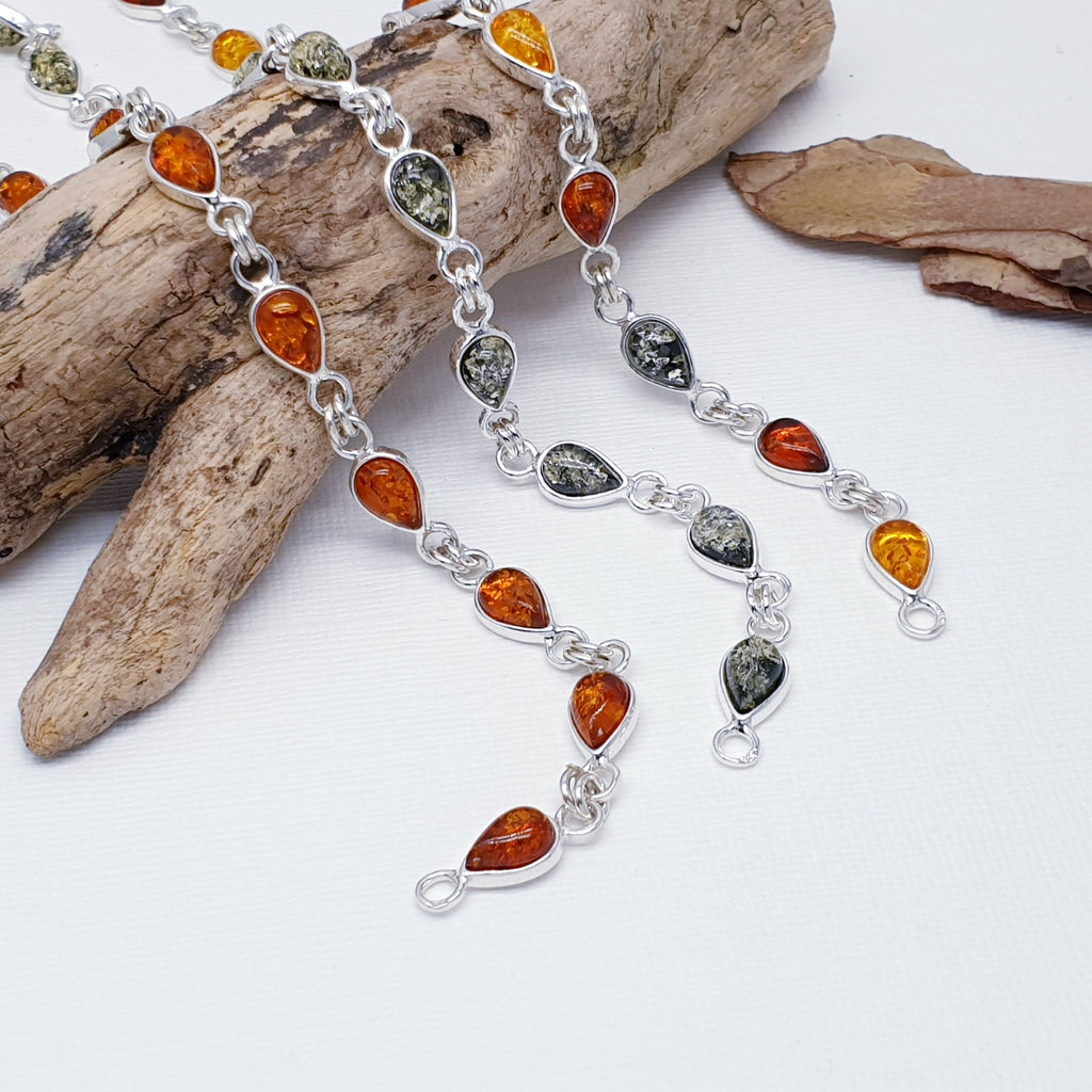 Our Green, Mixed or Toffee Amber Sterling Silver Oliwia Bracelet is perfect for everyday wear or special occasions.  This beautiful nature inspired bracelet features ten teardrop shaped, cabochon Baltic amber stones; with the choice of Green, Toffee or Mixed Amber stones.