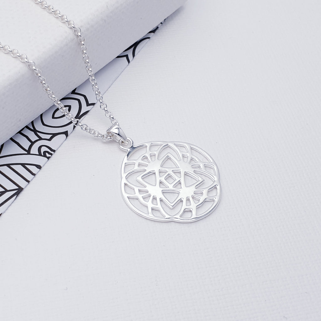 This pendant features a detailed cut out design inspired by the popular Mandala. The Mandala is a symbol used in Buddhism and Hinduism which represents the Universe. Recently this has become a very popular design used in jewellery, yoga clothing and accessories.