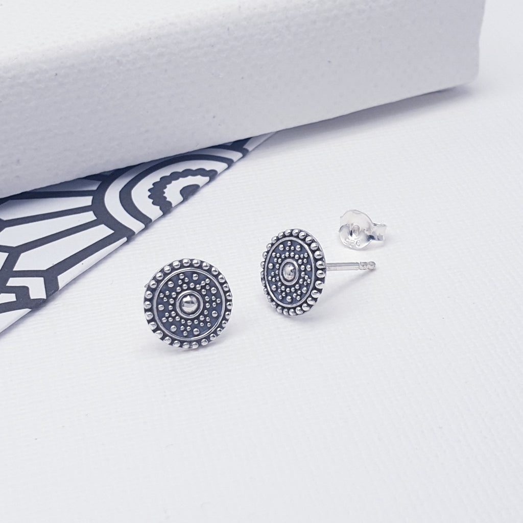 These studs feature an intricate cut out design enhanced by an oxidised finish and inspired by the popular Mandala. The Mandala is a symbol used in Buddhism and Hinduism which represents the Universe. Recently this has become a very popular design used in jewellery, clothing and accessories.