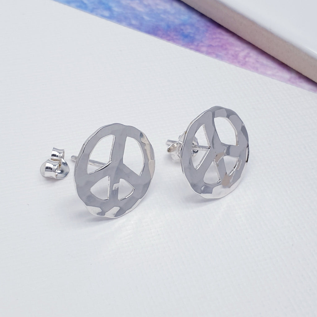 Each stud features an intricate, cut out, hammered peace sign. Symbolizing peace and love, an understated design, these studs will complement any outfit and add a flash of glamour to your day.