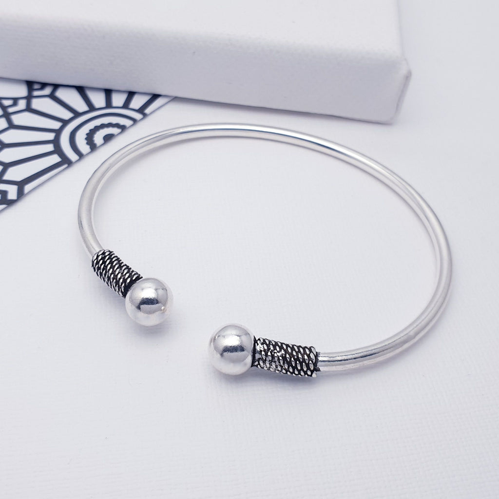 A beautiful design, this cuff bracelet features a Sterling Silver band with gorgeous Bali style, oxidised, pattern detailing. Silver balls sit at either end of an open cuff bracelet. Adjustable to most wrist sizes, this bracelet is light and easy to wear and is perfect as a gift for a loved one or as a little treat for yourself.