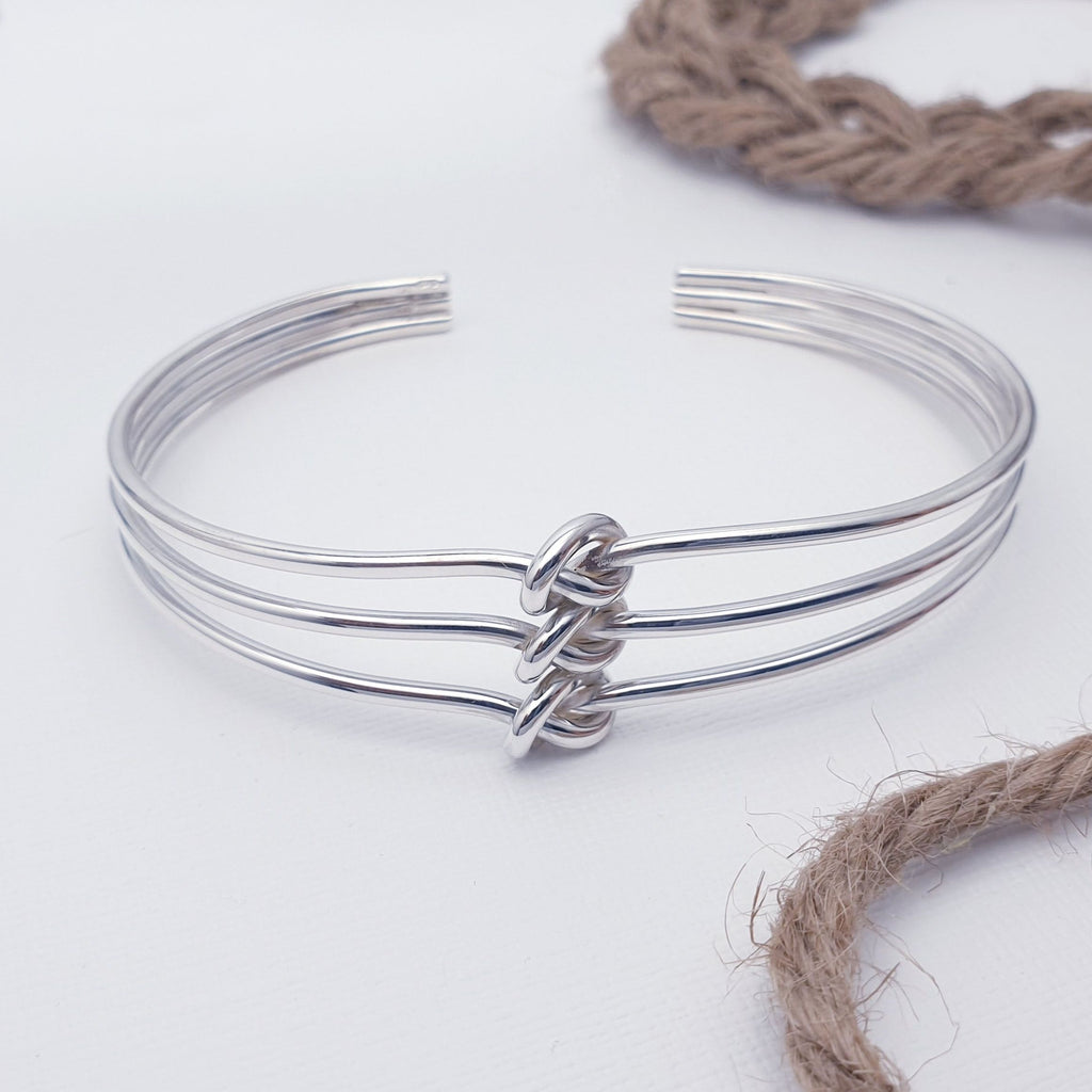 A beautiful design, this cuff bracelet features three fine Sterling Silver bands with three knots in the middle. Adjustable to most wrist sizes, this bracelet is light and easy to wear and is perfect as a gift for a loved one or as a little treat for yourself.