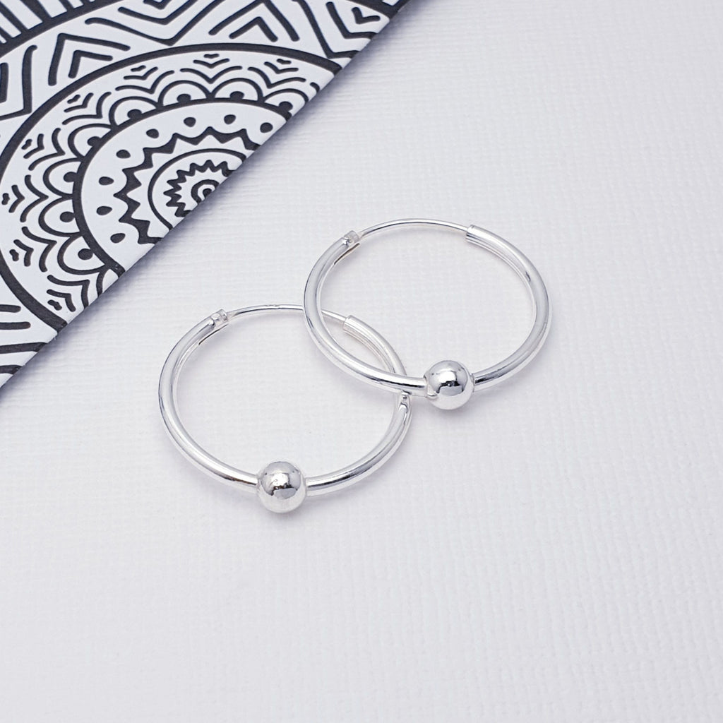 Our Silver 2cm Ball Hoops are ideal for everyday wear and can transition effortlessly from work to play.  These Sterling Silver hoops feature a ball in the middle of the earring, to add extra detail to the design.