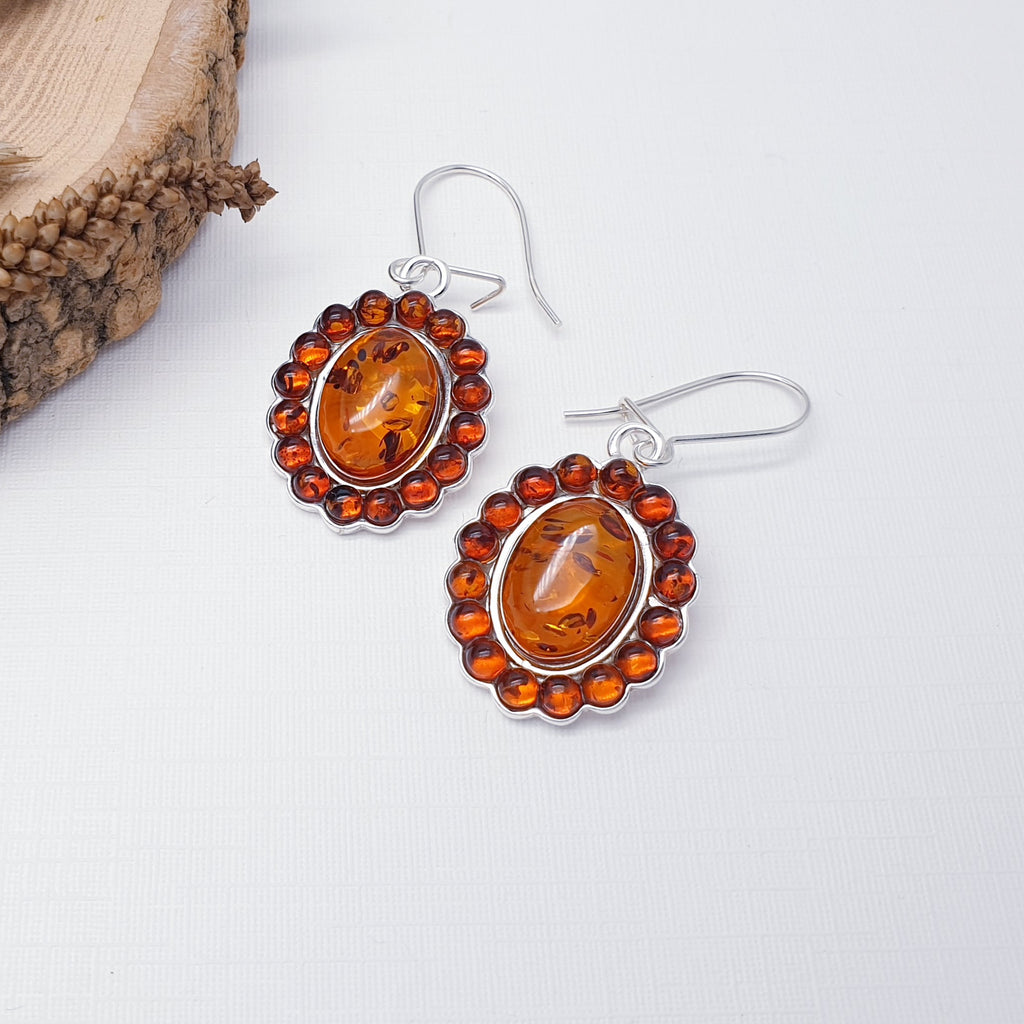 Each earring features an oval Baltic Toffee Amber stone with surrounding smaller circles, creating an exciting design. The perfect size, big enough so that the colour of the Amber can be appreciated but small enough so that they are not overpowering. These earrings will soon become everyday favourites. A closed hook fastening means that they are extra secure so you won't have to worry about loosing them.