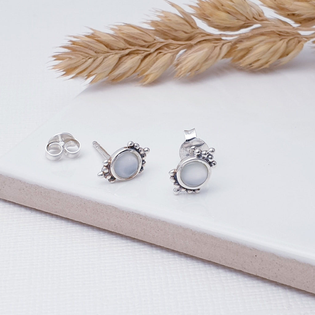 Our Sterling Silver Lunar Twilight Studs are perfect for every day wear.  Sometimes less is more, and that is definitely the case with this gorgeous pair of Moonstone studs. Featuring tiny round Moonstone stones in simple silver settings, these earrings have intricate, dotted detailing above and below the stone.