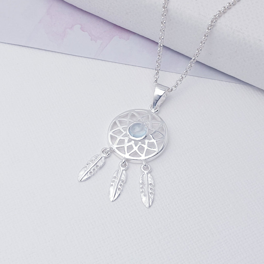 Our Blue Topaz Sterling Silver Dream Catcher Pendant (chain not included) is so cute as would be and perfect for everyday wear.  This stunning pendant features small, cabochon Blue Topaz' in the center of a beautifully detailed dream catcher, with three dangly feathers.