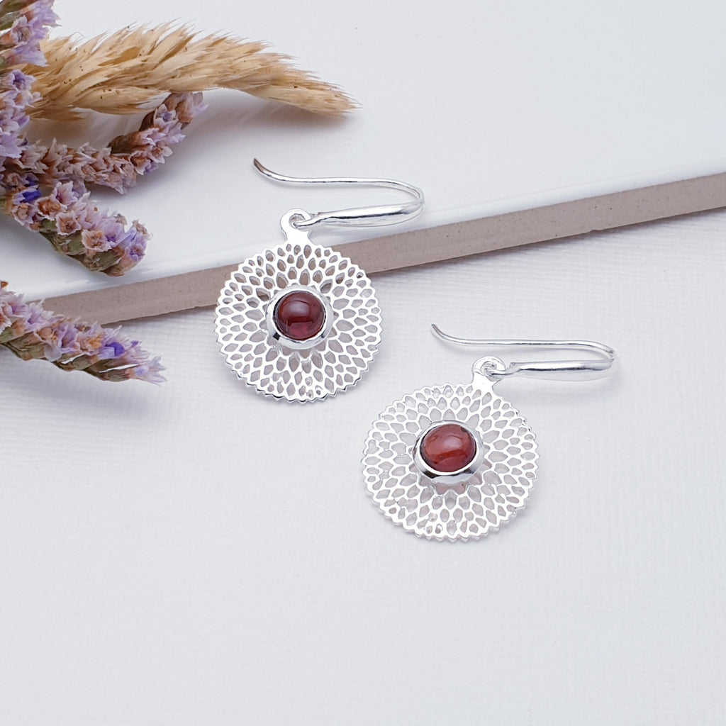 Our Garnet Sterling Silver Chrysanthemum Earrings are perfect for everyday wear or special occasions.  These stunning earrings feature small, cabochon Garnets in the center of a beautifully detailed flower. 