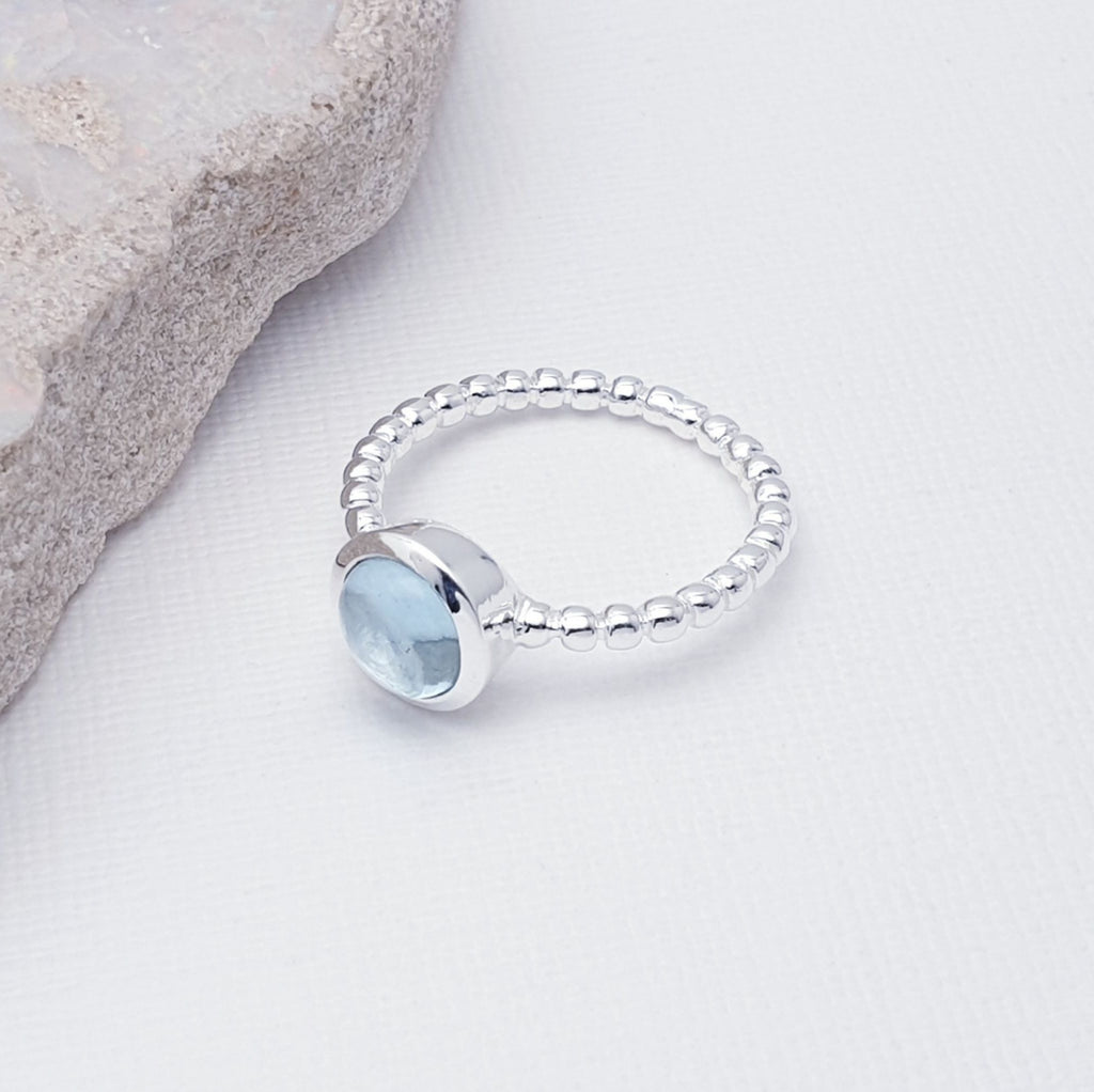 Our Blue Topaz Feather Ring is perfect for everyday or special occasion wear.  A beautiful design, this ring features a stunning, round, cabochon, Blue Topaz stone in a simple lowered setting. The band is shaped in a bubble-like ball design, to add extra detailing.