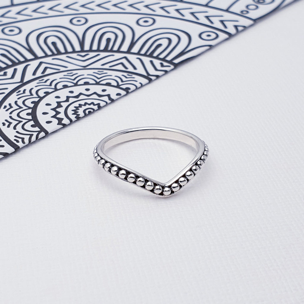 Our Sterling Silver Beaded Wishbone Ring is perfect for everyday wear or special occasions.  Stop wishing and start wearing this dainty and delightful Sterling Silver Beaded Wishbone Ring! The simple beaded Sterling Silver band design makes it perfect for any occasion and adds an air of subtle sophistication to your look. Hopeful and whimsical - it's bound to bring you luck!