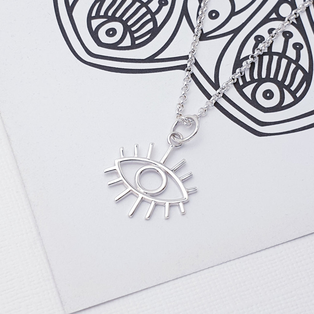 Our Sterling Silver Eye Pendant (chain not included) is perfect for everyday wear and will transition effortlessly from work to play.  Look stylish and chic this summer with this beautiful boho-inspired Sterling Silver Eye Pendant. The intricate design and high quality materials make this pendant a timeless accessory to add to your look.