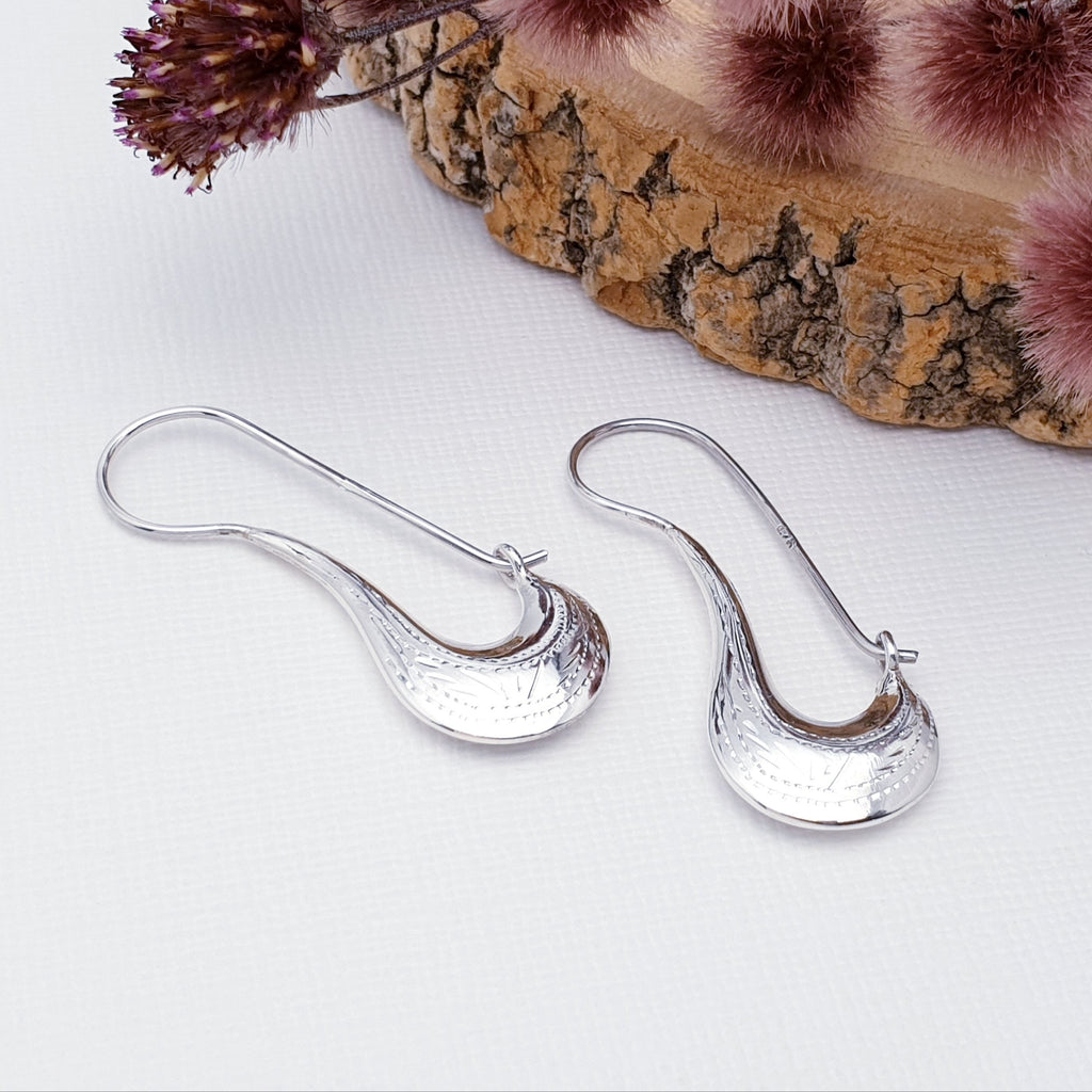 These Sterling Silver hoops feature a beautiful, intricate, etched pattern which adds depth and intrigue. The Snap fastening means that they are extra secure so you won't have to worry about loosing them.