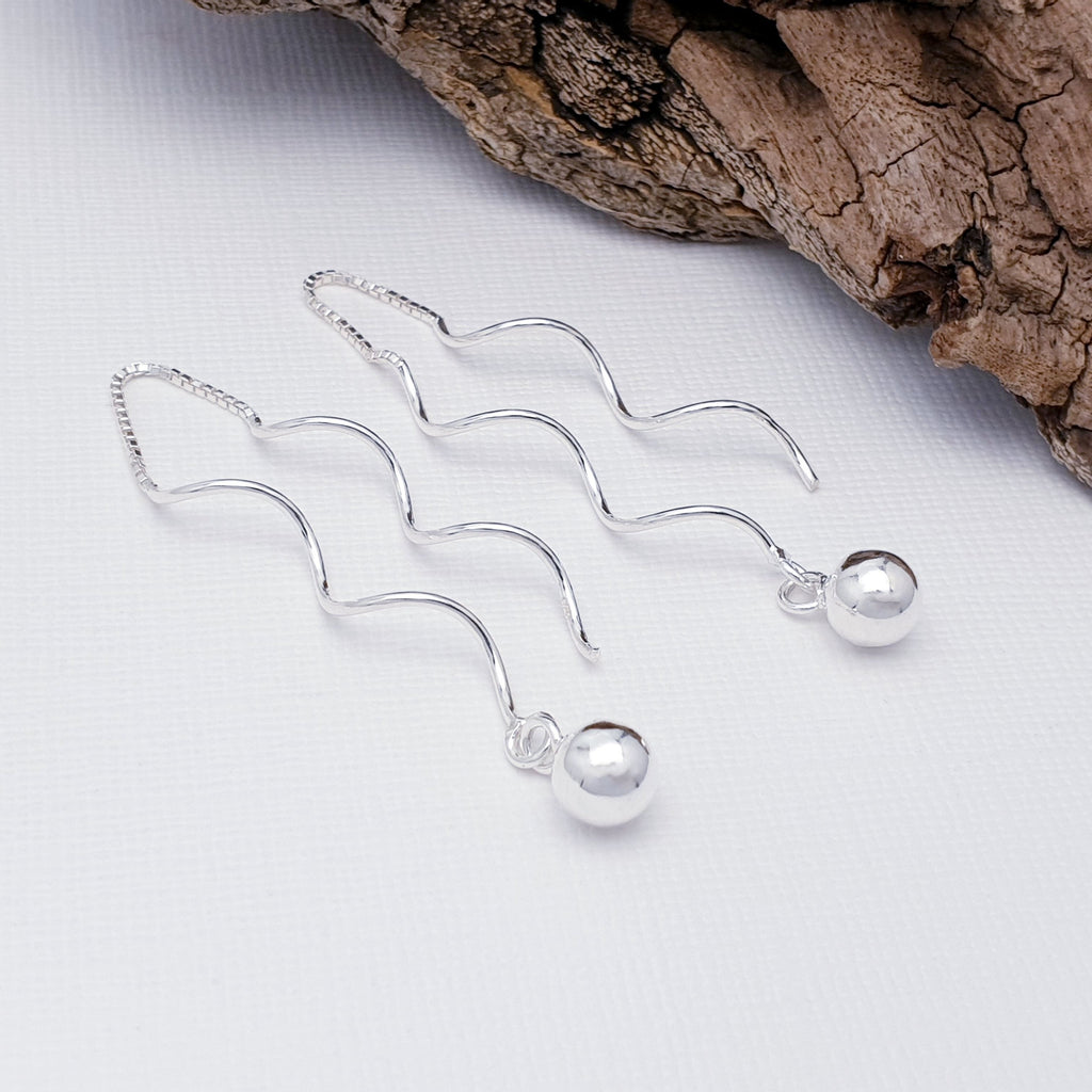 a pair of Sterling Silver Twisted Ball Pull Through Earrings