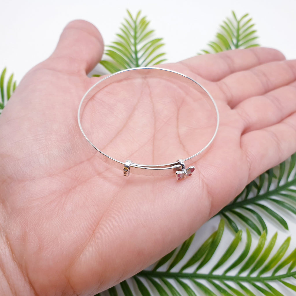 A beautiful, dainty bangle made in Sterling Silver. An extra special design with a tiny pink butterfly charm and 3 diamante diamonds. 