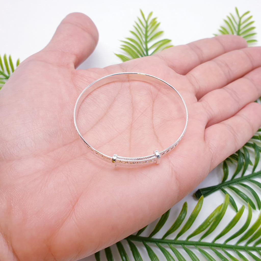 Our Sterling Silver Botanical Child Bangle is perfect for everyday wear or special occasions.