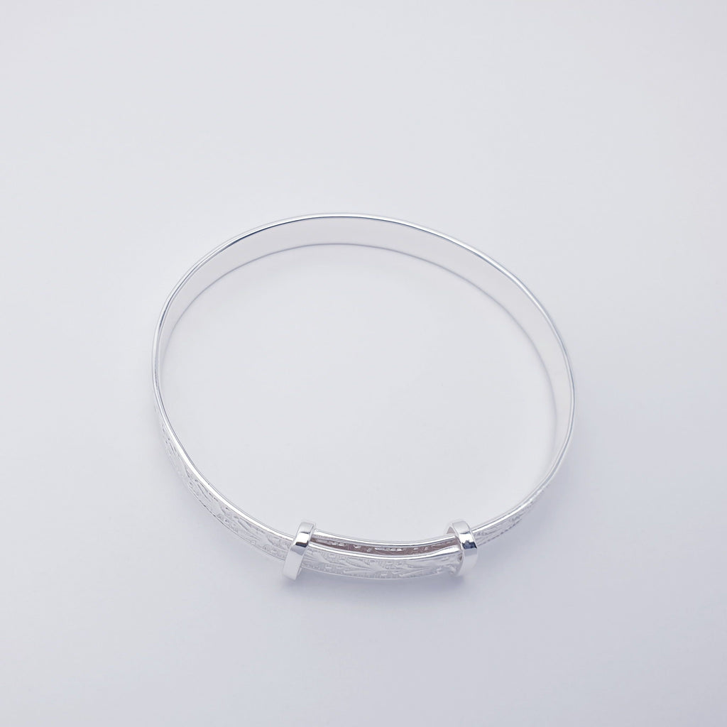 Our Sterling Silver Botanical Child Bangle is perfect for everyday wear or special occasions.