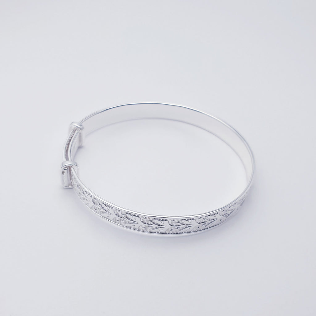 Our Sterling Silver Botanical Child Bangle is perfect for everyday wear or special occasions.