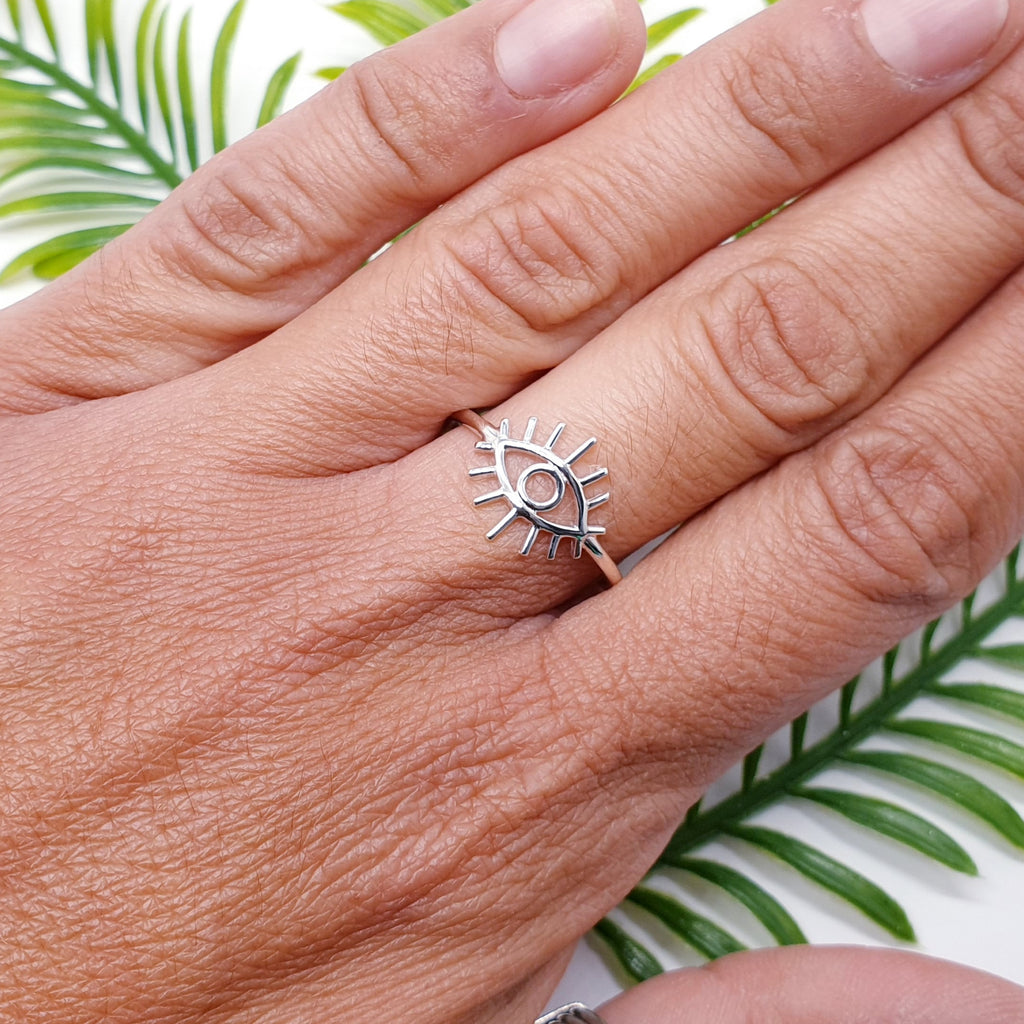 Dainty sterling silver all seeing eye ring on a finger