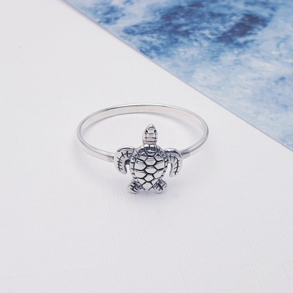 dainty sterling silver turtle ring displayed on a white background