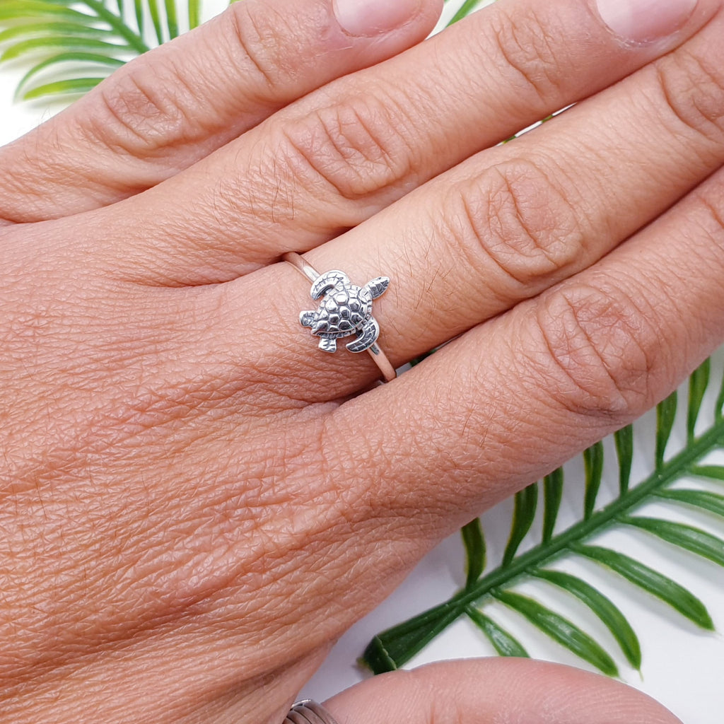 dainty sterling silver turtle ring on a hand