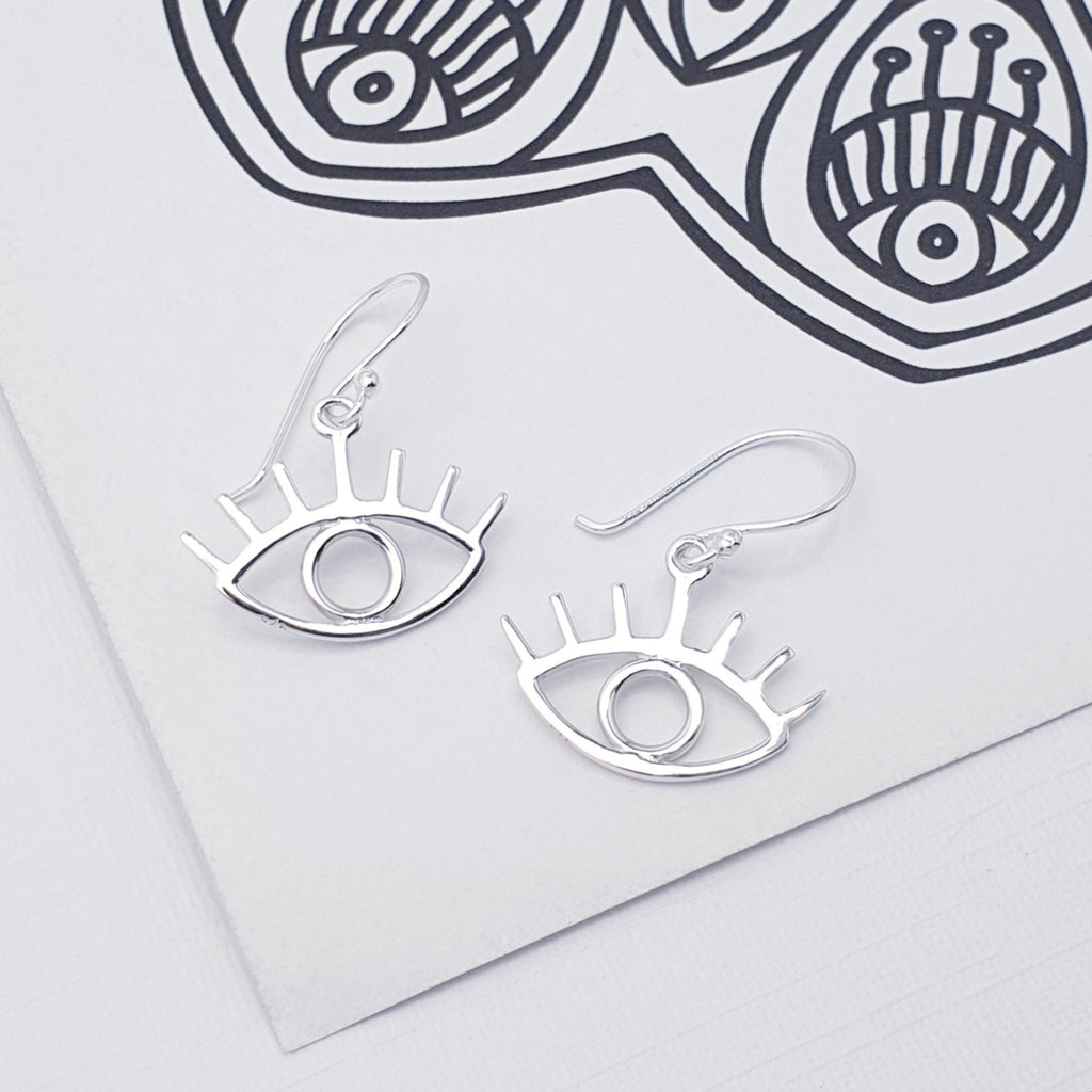 dainty sterling silver dangle drop mystic eye earrings DISPLAYED ON A WHITE BACKGROUND