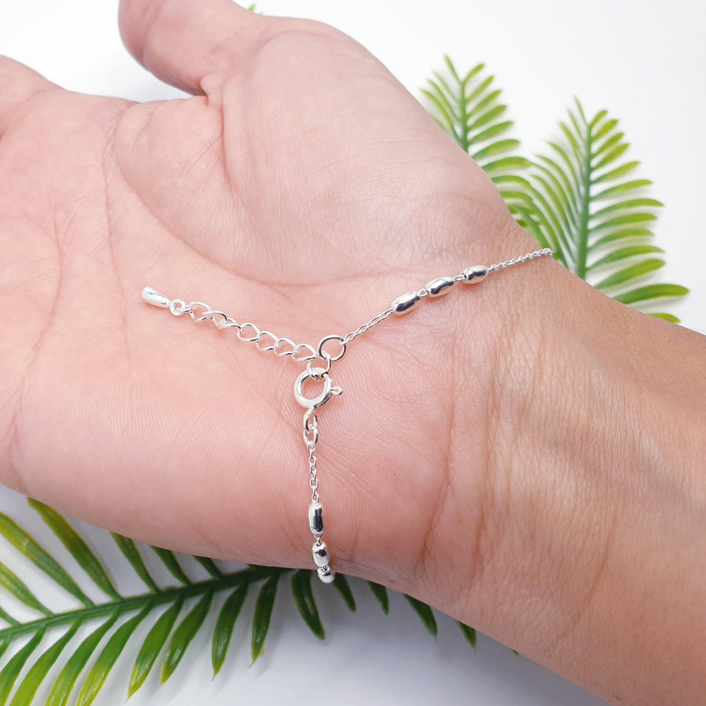 handmade sterling silver oval bead bracelet on a fine belcher style chain.