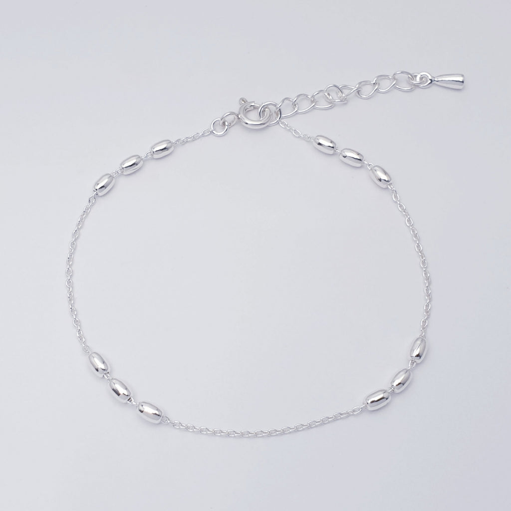 handmade sterling silver oval bead bracelet on a fine belcher style chain.