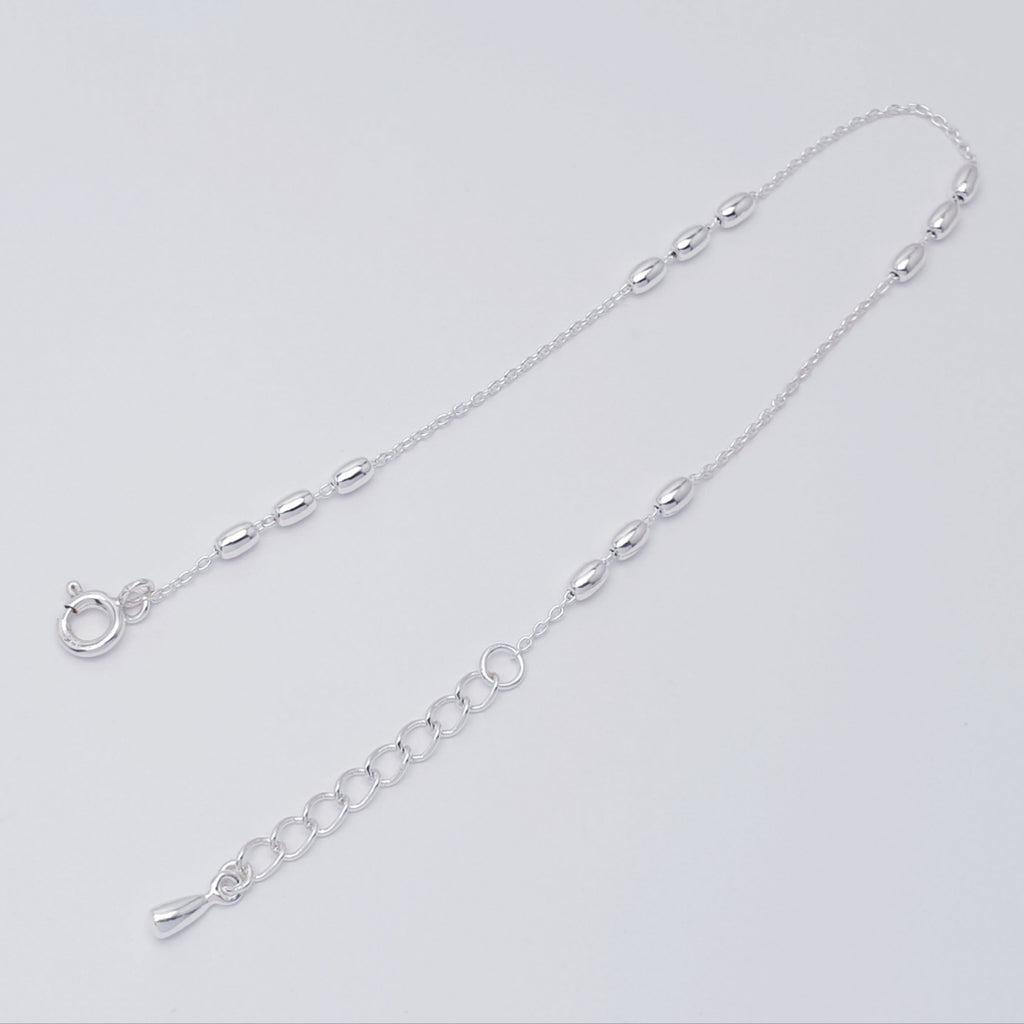 handmade sterling silver oval bead bracelet on a fine belcher style chain.