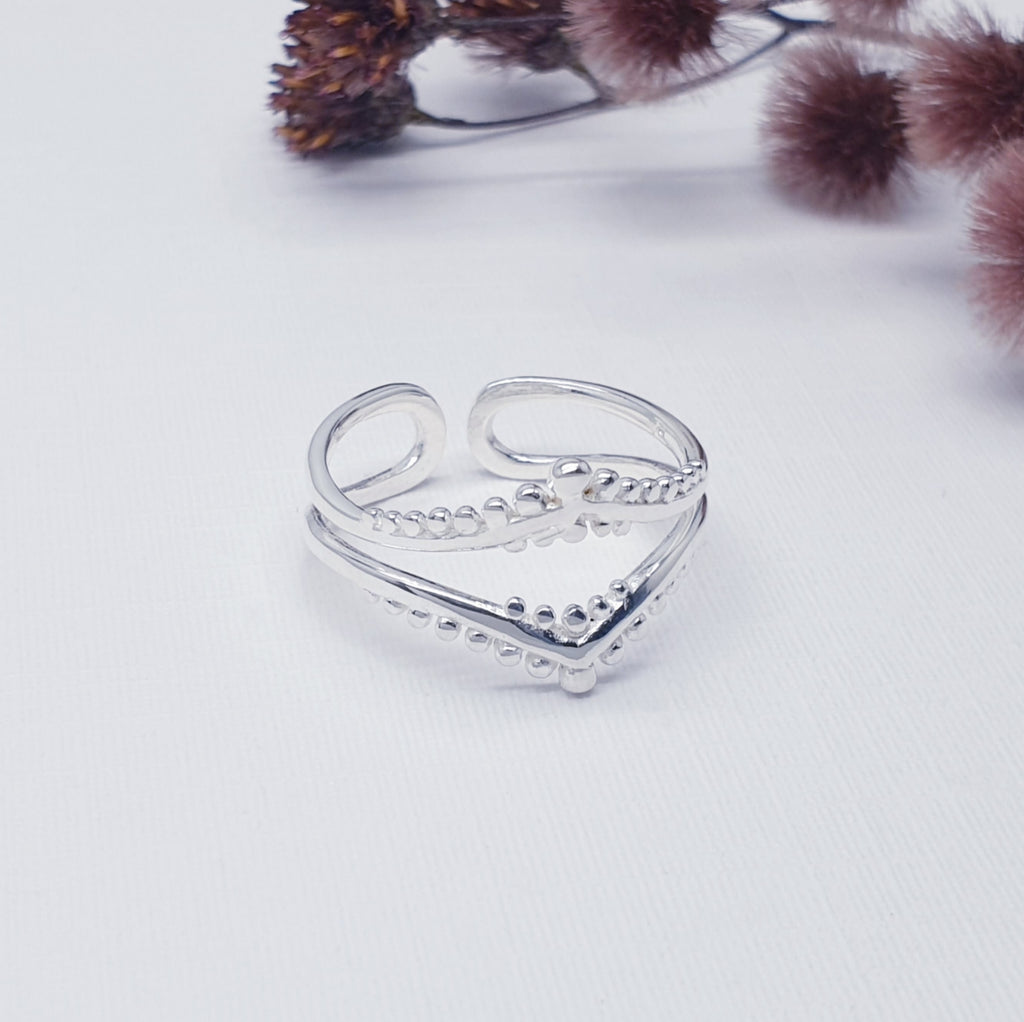 adjustable, handmade boho sterling silver ring, displayed on a white background 