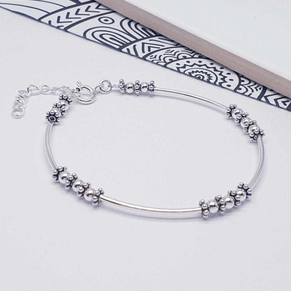 intricate indo beaded sterling silver adjustable bracelet displayed on a white background