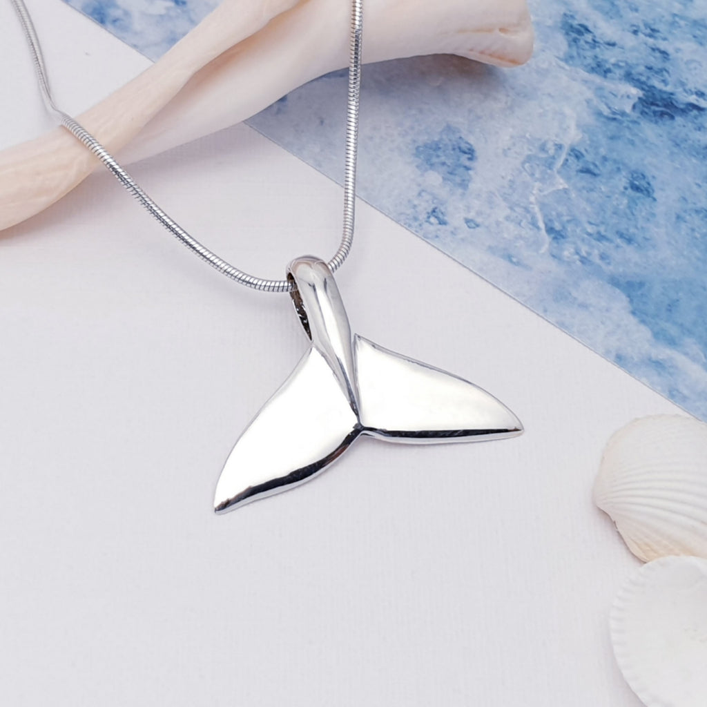 polished sterling silver whale tail fin pendant.