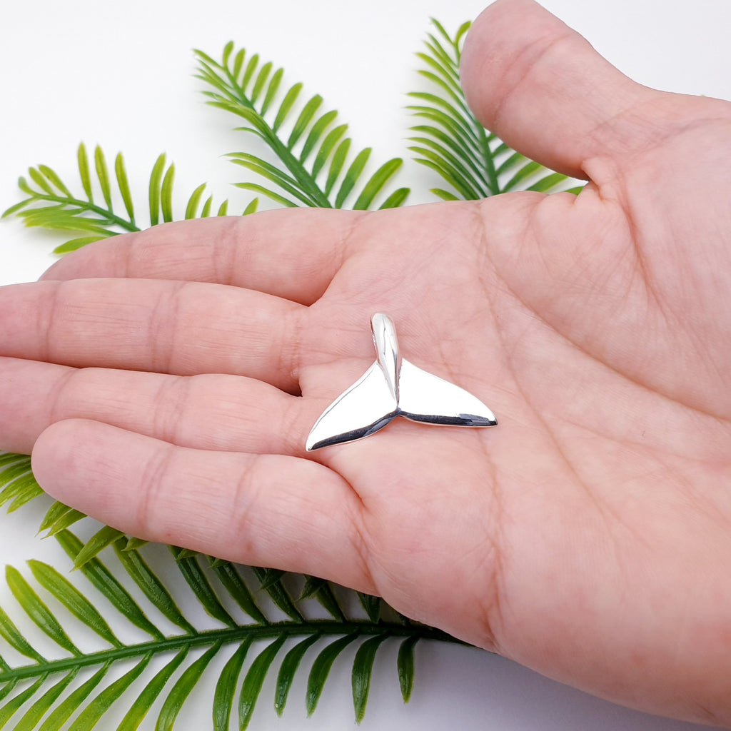 polished sterling silver whale tail fin pendant.