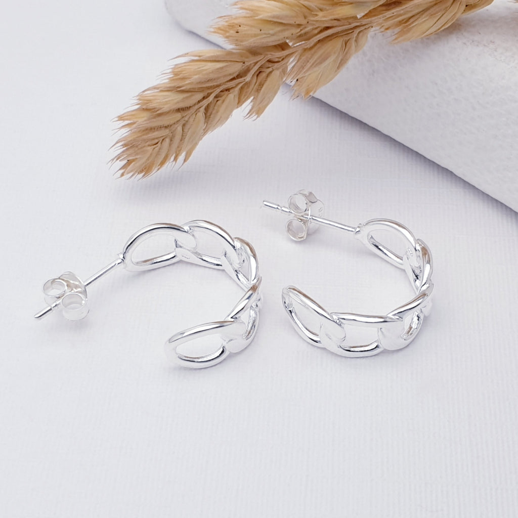 Sterling Silver Curb Link 1.6 cm Half Hoops on a white background with barley along the top as decoration.