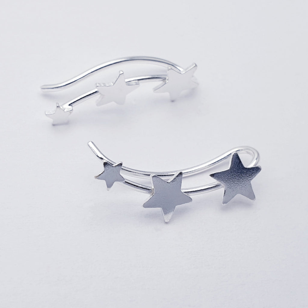 Silver star-shaped bracelet on a light gray background
