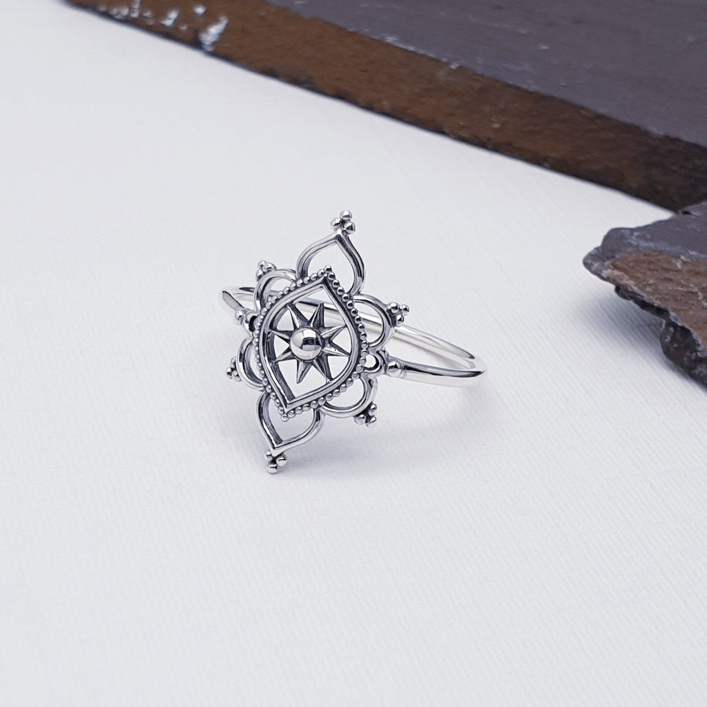 Our inner peace mandala ring against white with slate in the background as decoration