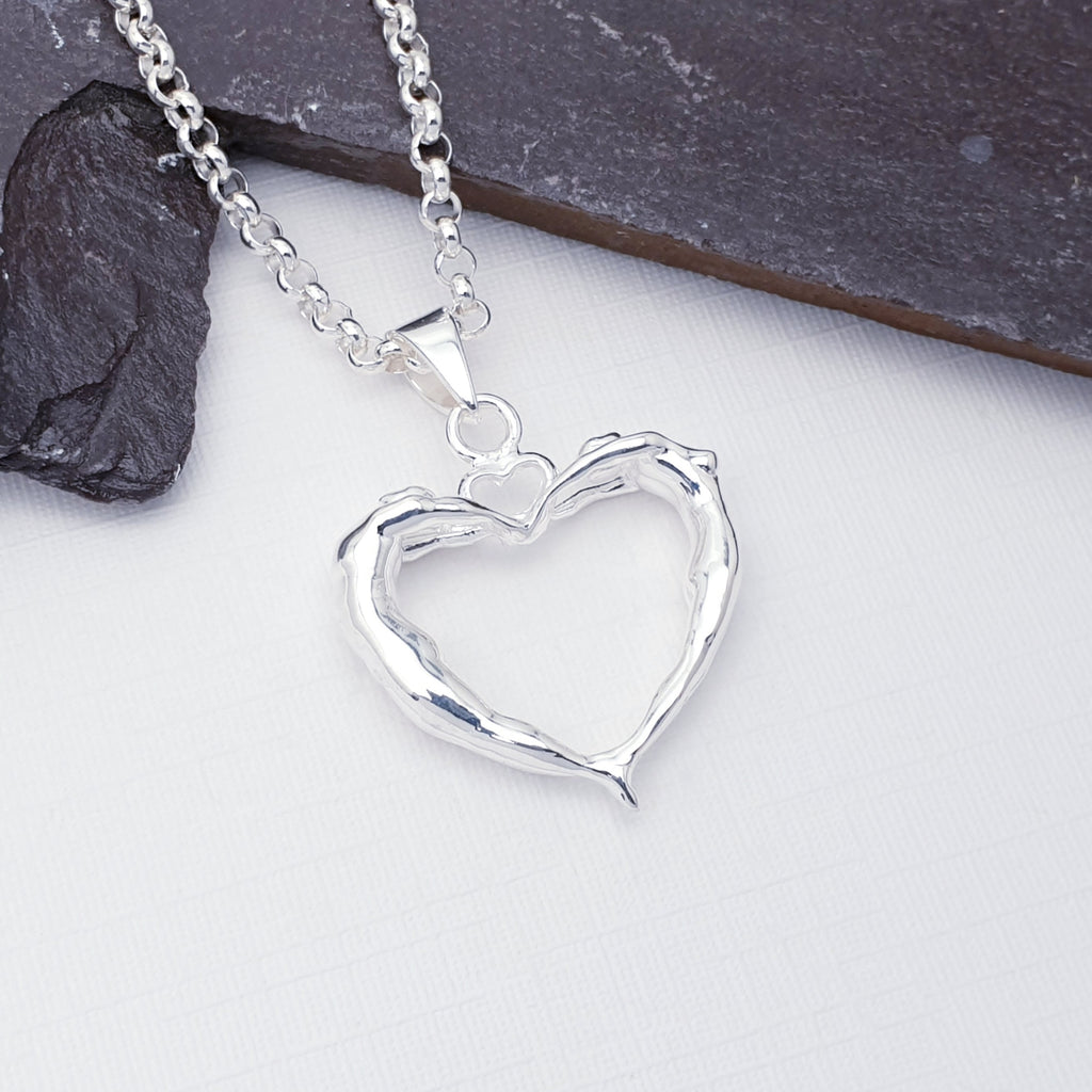 Our lovers heart pendant on a chain pictured against white with slate in the background as decoration