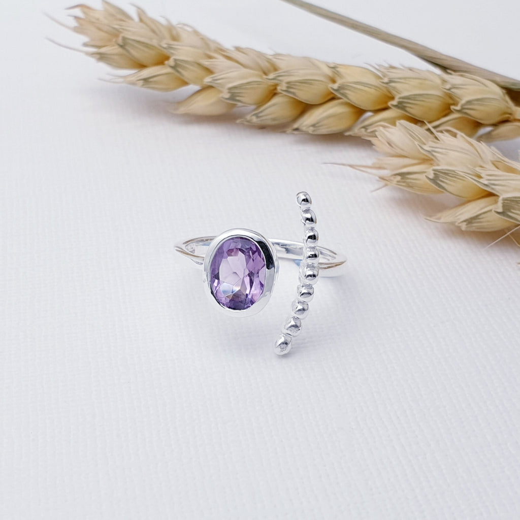 Our Amethyst Silver Bubble Open Ring is perfect for everyday wear or special occasions.  This ring features a beautiful, cabochon, oval, Amethyst stone in a simple Sterling Silver setting. Open at the front, this ring wraps beautifully around the finger, with the Amethyst stone on one side