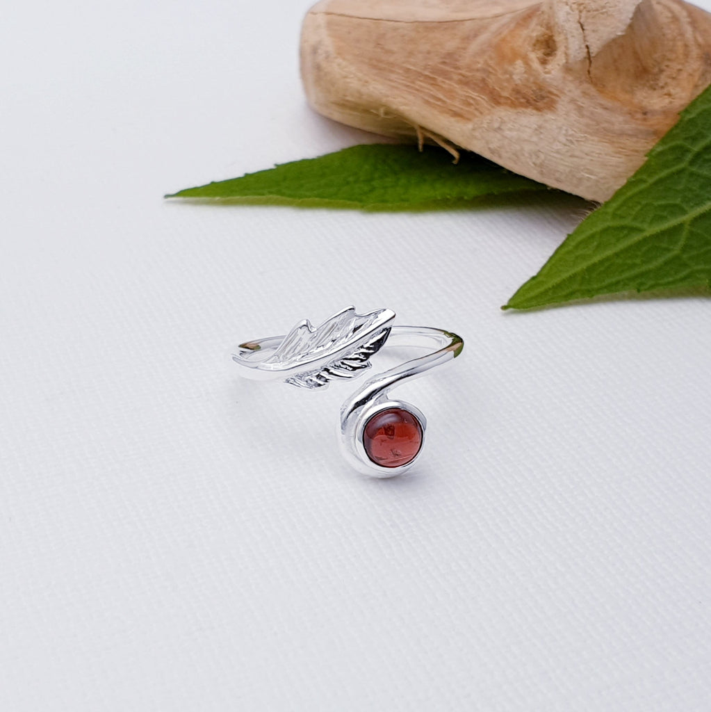Our Garnet Leaf Ring is perfect for everyday wear or special occasions.  This elegant Garnet Sterling Silver Leaf Ring is set with a beautiful round cabochon Garnet stone and detailed with an intricate leaf design. Perfect for adding a hint of sparkle to your look, this statement ring will bring style and sophistication to any outfit.