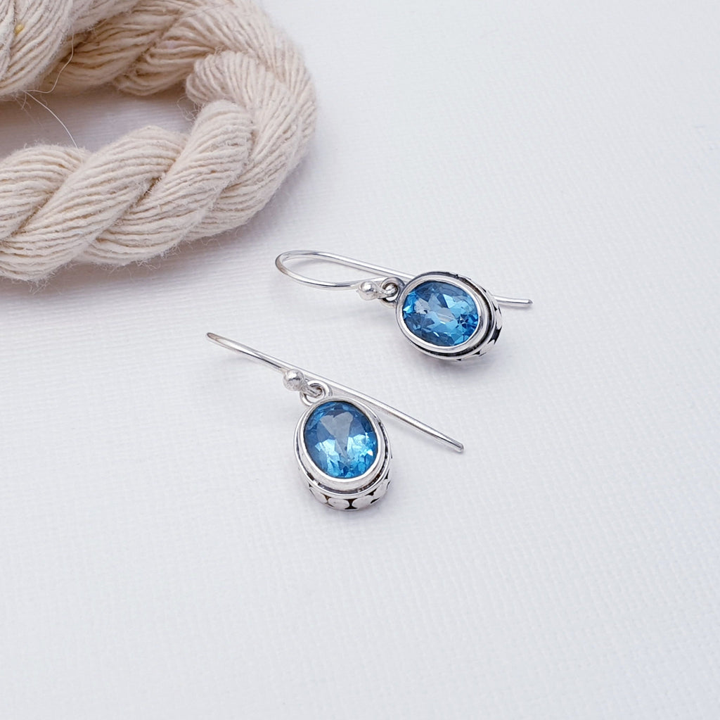 These Blue Topaz Sterling Silver Oval Detailed Earrings feature beautiful oval shaped, Blue Topaz stones in intricate, angular, Sterling Silver settings. You'll love the timeless, elegant details these earrings bring to any look. Make a statement and add a touch of sophistication to your style today.
