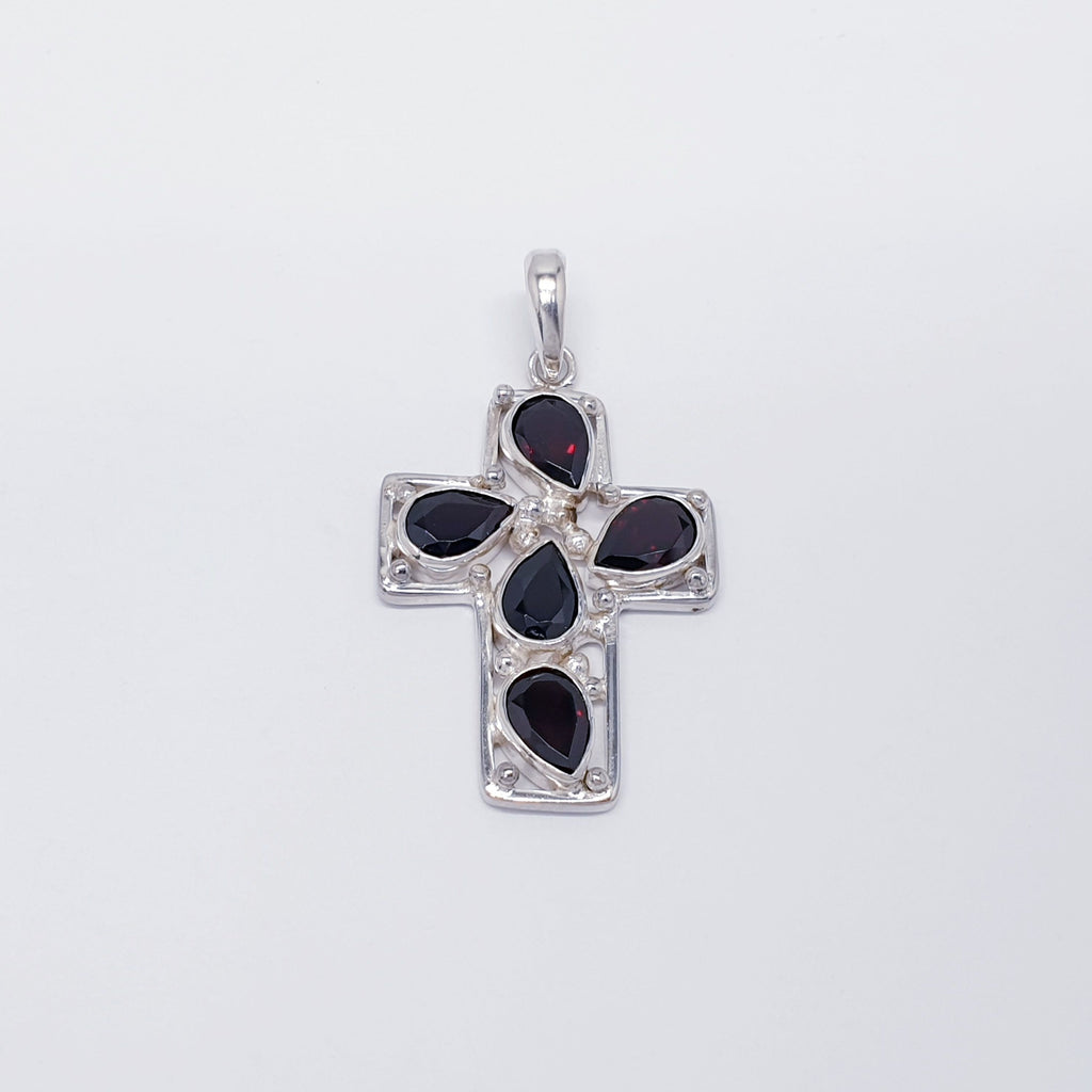 sterling silver cross pendant with garnet teardrop gemstones.