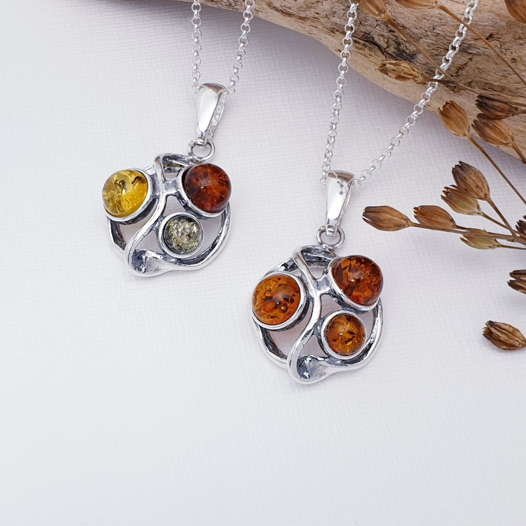 Two Toffee and Mixed Amber Sterling Silver pendants on chains with foliage decor