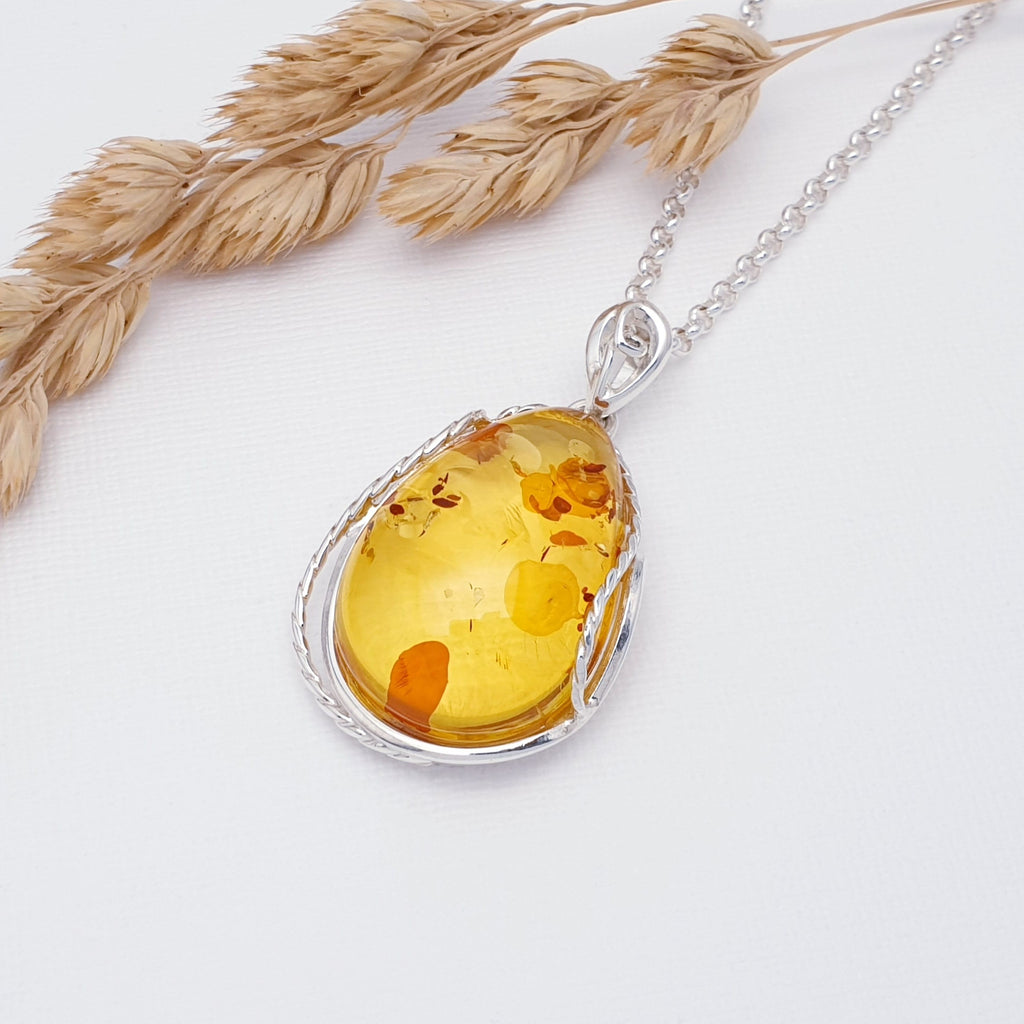 large toffee amber pendant on a sterling silver chain.