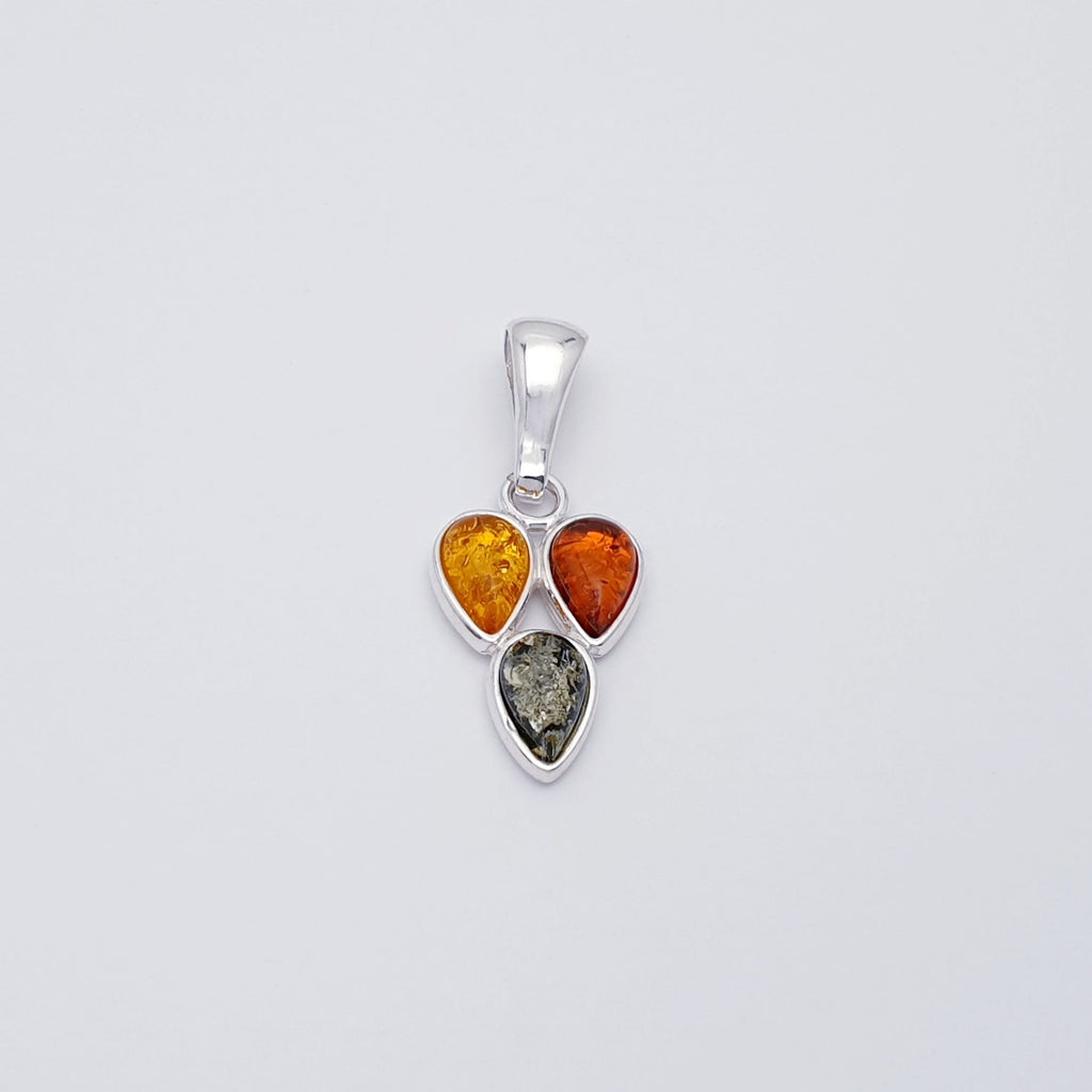 a mixed amber pendant with three teardrop shaped gemstones in a sterling silver setting