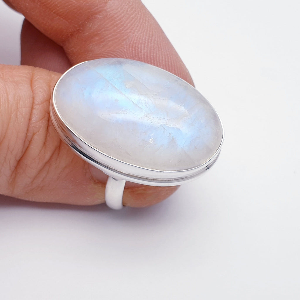large oval moonstone ring on thumb