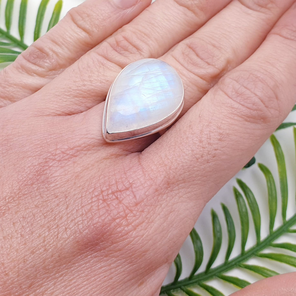 Large teardrop shaped moonstone ring on a hand