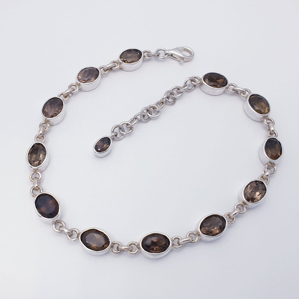 An oval gemstone bead smoky quartz and sterling silver bracelet flat lay