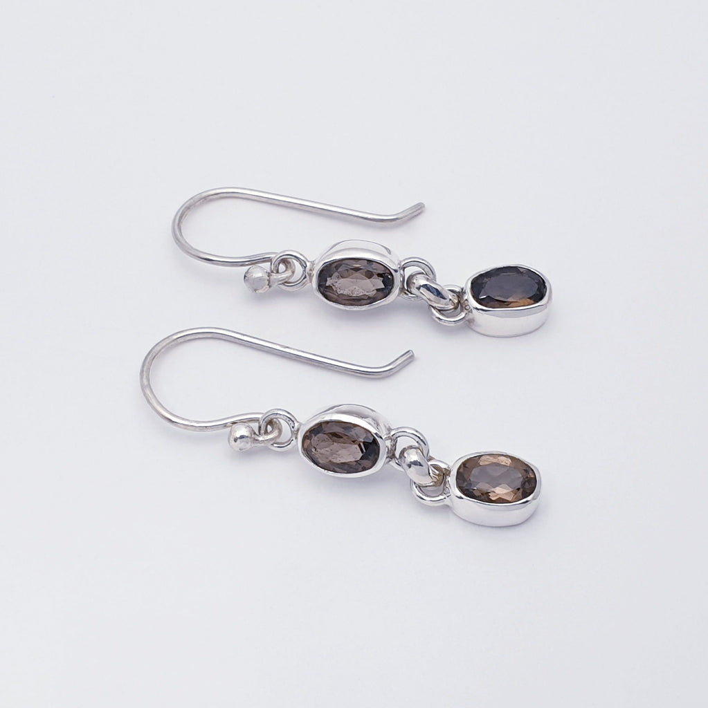 A pair of dainty smoky quartz and sterling silver earrings side view
